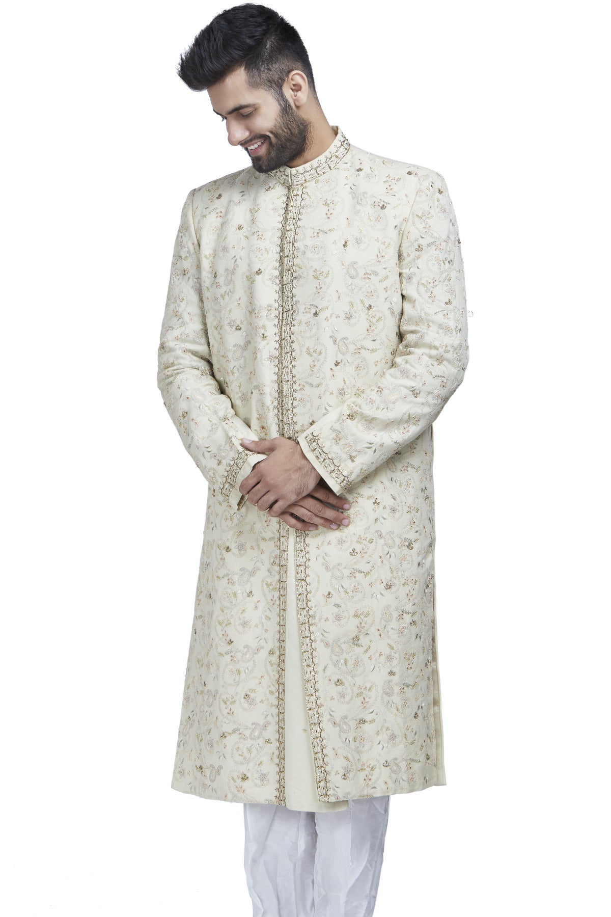 The perfect muse to a palace backdrop or even a gorgeous garden, this ivory sherwani with zari and threadwork is paired with ivory churidars.