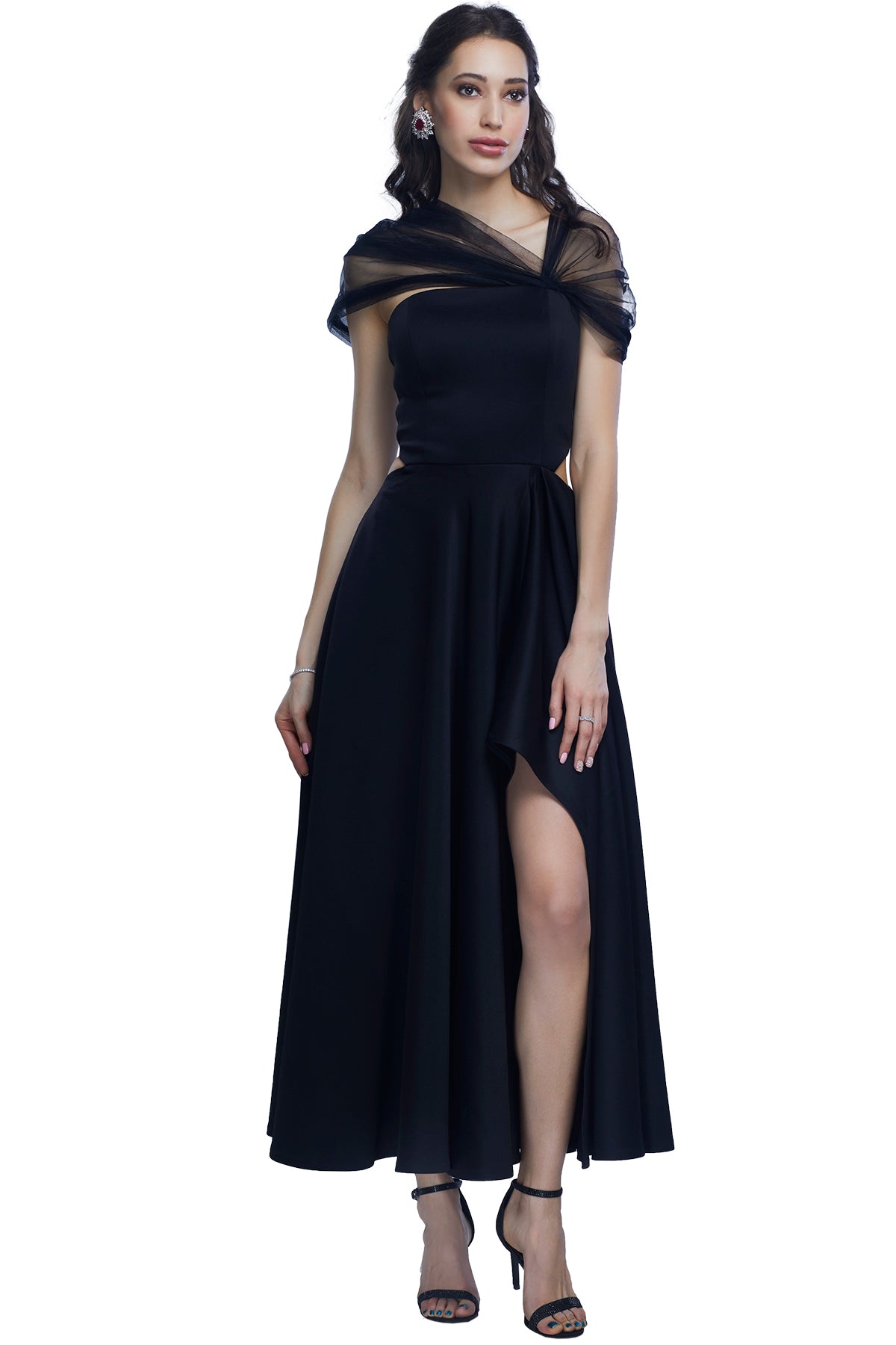 Black gown in scuba fabric with a high front side slit and net off shoulder drape.