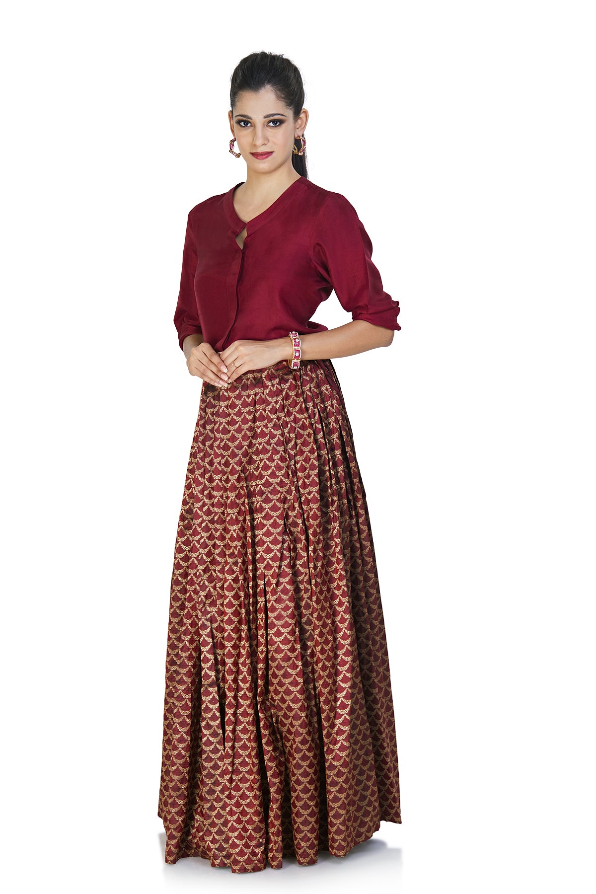 Twirl to all your favorite Bollywood songs this Shaadi season with this breezy outfit minus all the worries. The red top looks best when it is tucked inside the rich brocade skirt.