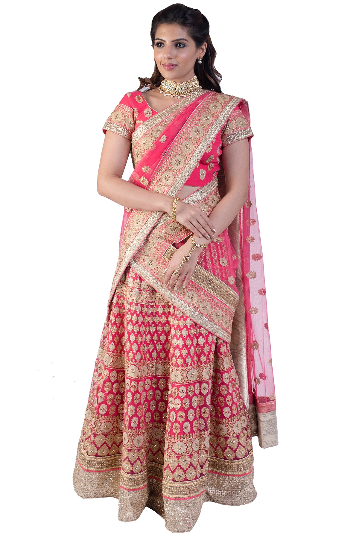 Pretty in pink! The outfit has detailed gold zardosi work on both the lehenga and the blouse. Drape around it a matching dupatta to complete the look.