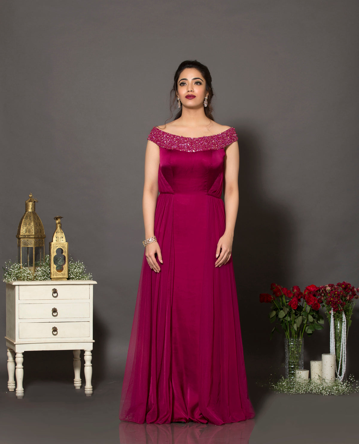 A beautiful satin georgette and soft net gown with the neckline highlighted using sequins and pearls.