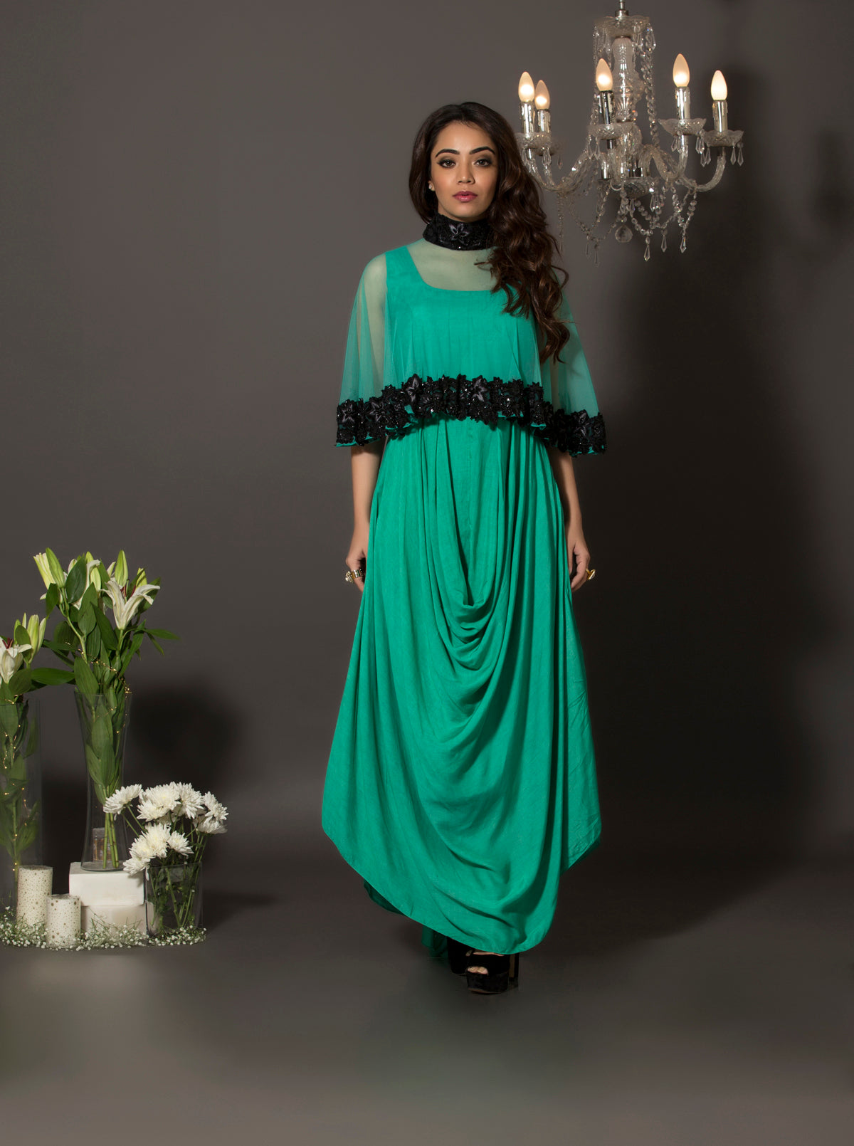 The beautiful cowl dress in soft mul is a versatile piece that can be worn with our without the cape. The cape is made of soft net with handcrafted floral thread embroidery at the bottom and is highlighted with sequins and pearls.
