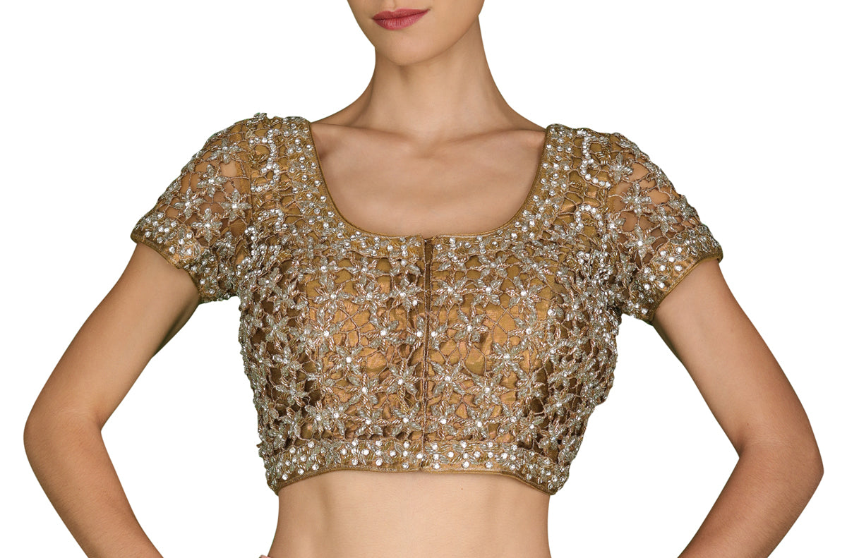 An every wardrobe staple for the wedding season, weave in some serious magic with this dark gold blouse with delicate cut-work embroidery highlighted with stones.