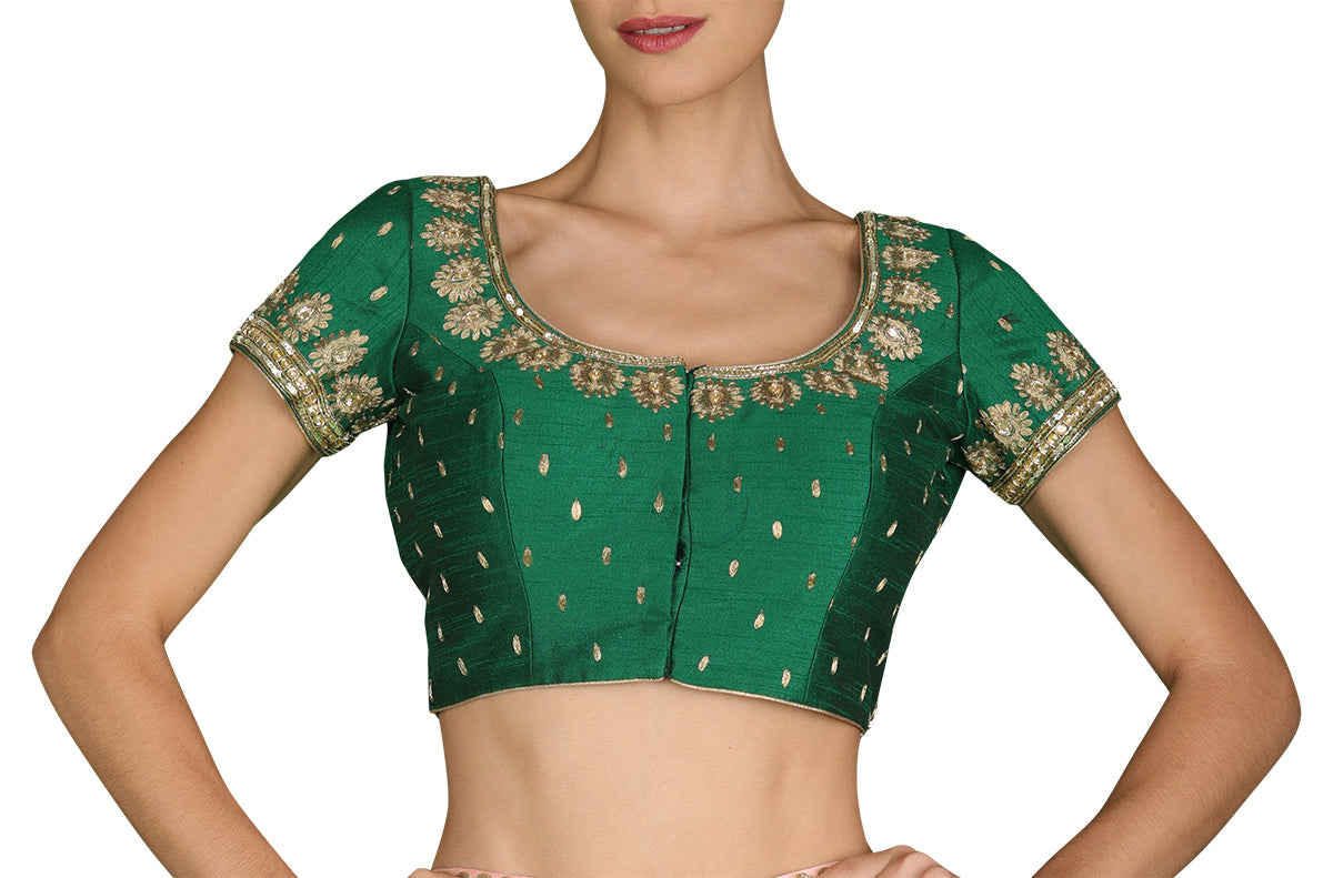 A must-have for your next destination palace wedding, this hand-embroidered dark green silk blouse is highlighted in light gold.