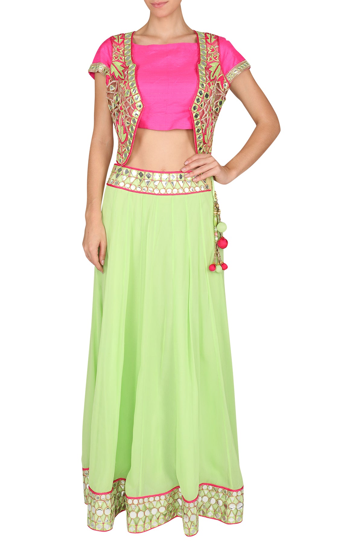 Painting a medley of moods all fashionable and festive - bring some life to your wardrobe with this parrot green mirror georgette lehenga, a plain pink silk blouse and a cutwork mirror embroidered short jacket.