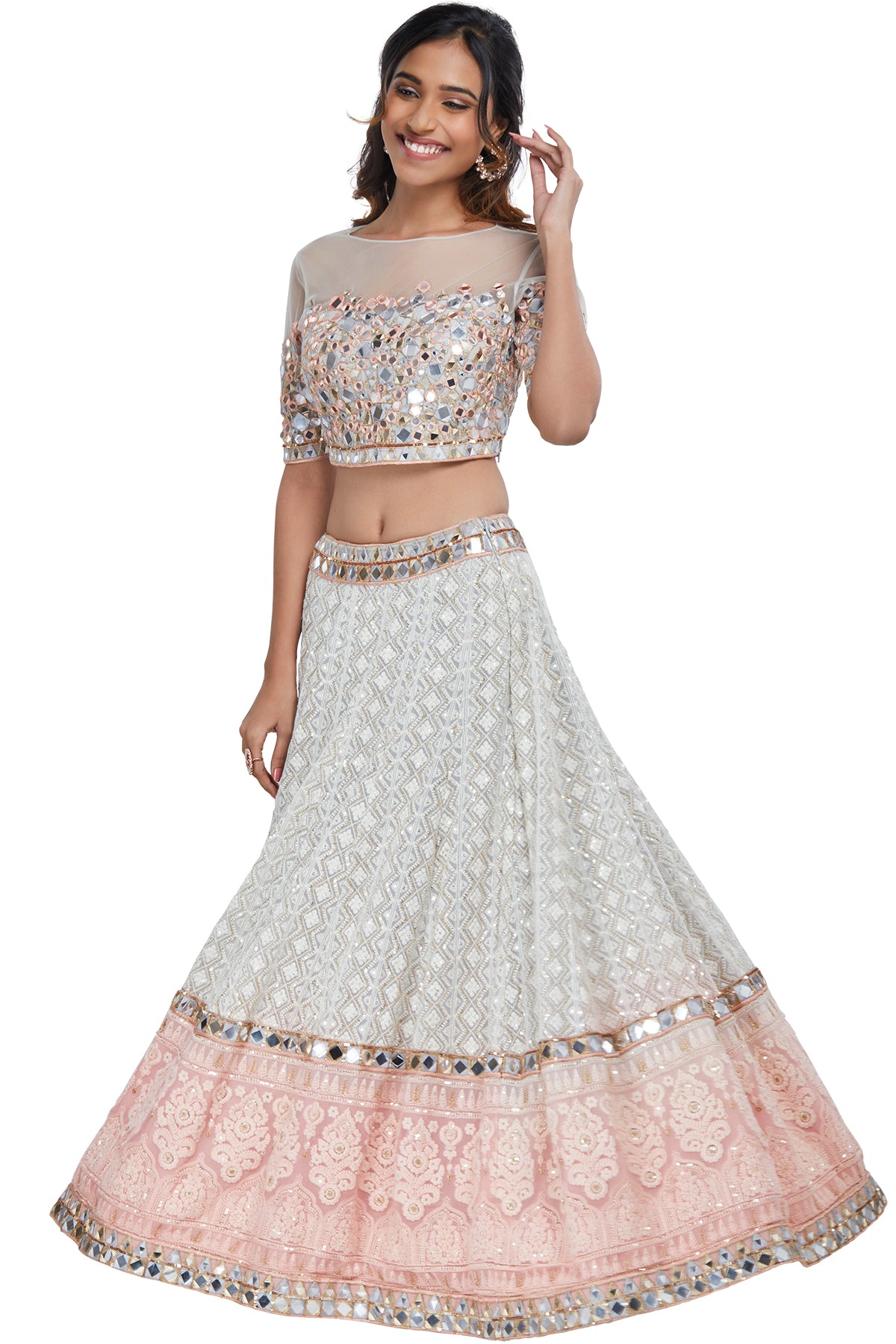 Mirror a mystical aura of glamour and make all the right vows toward high fashion in this mirror work blouse over a grey and pink shaded lucknowi lehenga set with a pink net dupatta.