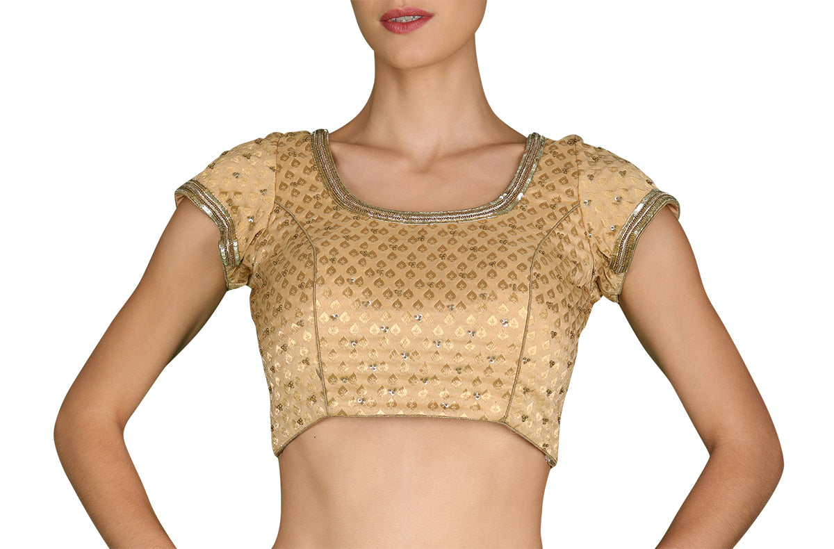With its unwavering whiff of class, rent out our ever-handy light gold brocade blouse with subtle gold hand embroidery.