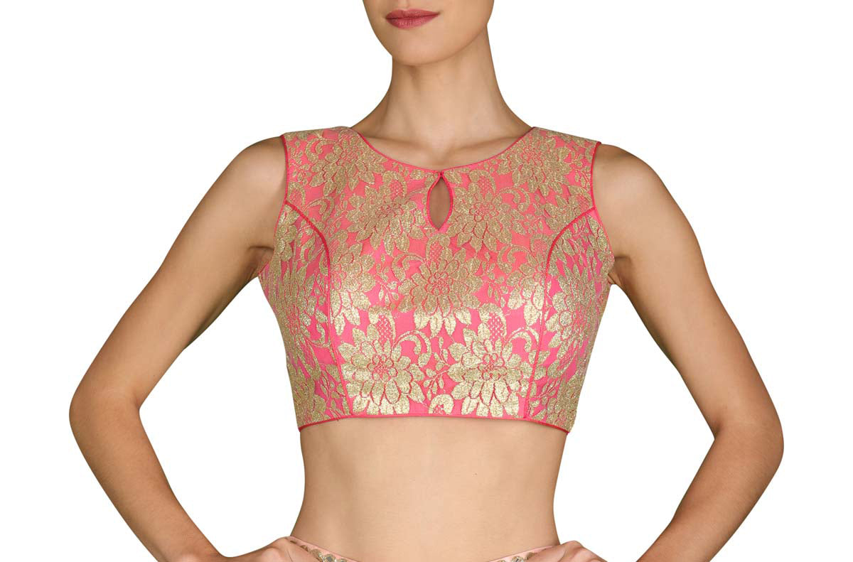 Double the celebrations in this pink and gold lace fabric blouse with slight in-cut sleeves and a keyhole cutout in the front and back.
