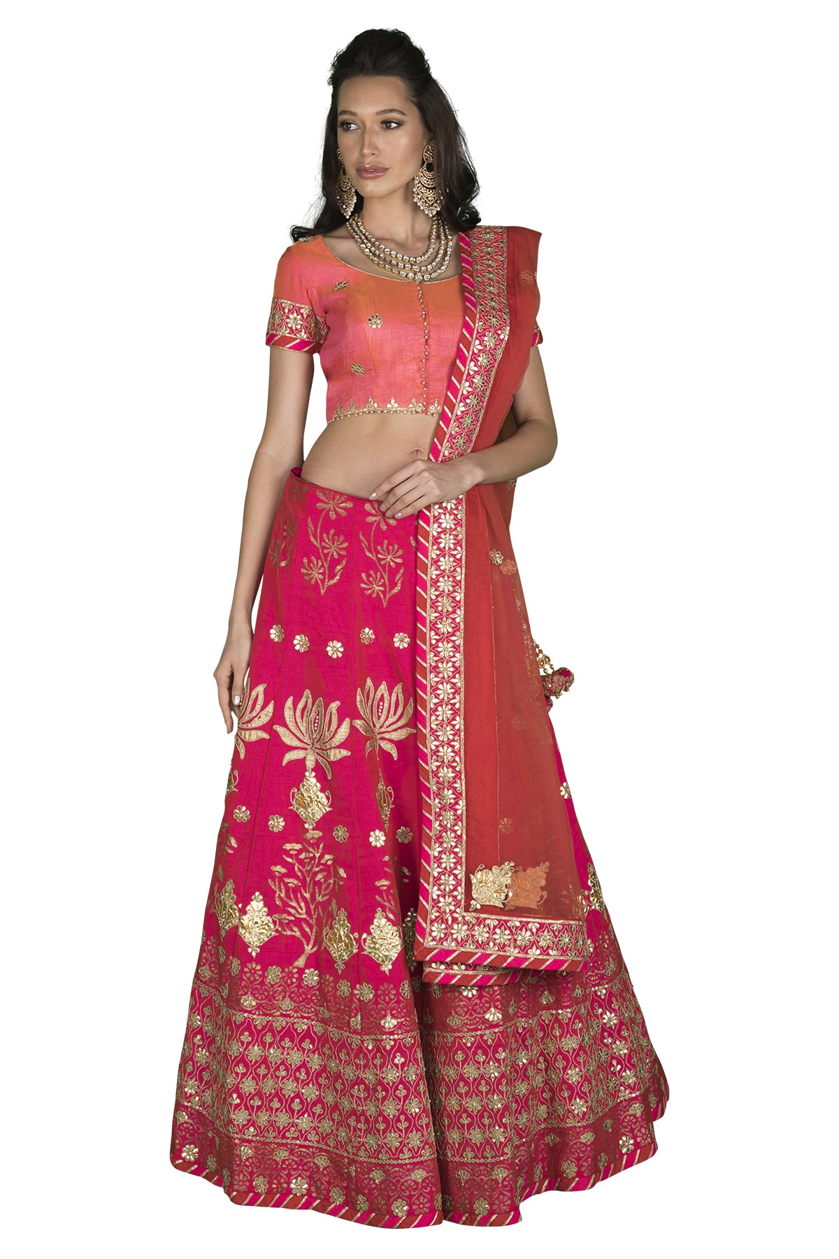 In a medley of the most festive colours, this pink & orange two-toned silk choli will sweep you away with its pink gota and threadwork lehenga decorated with lotus motifs.