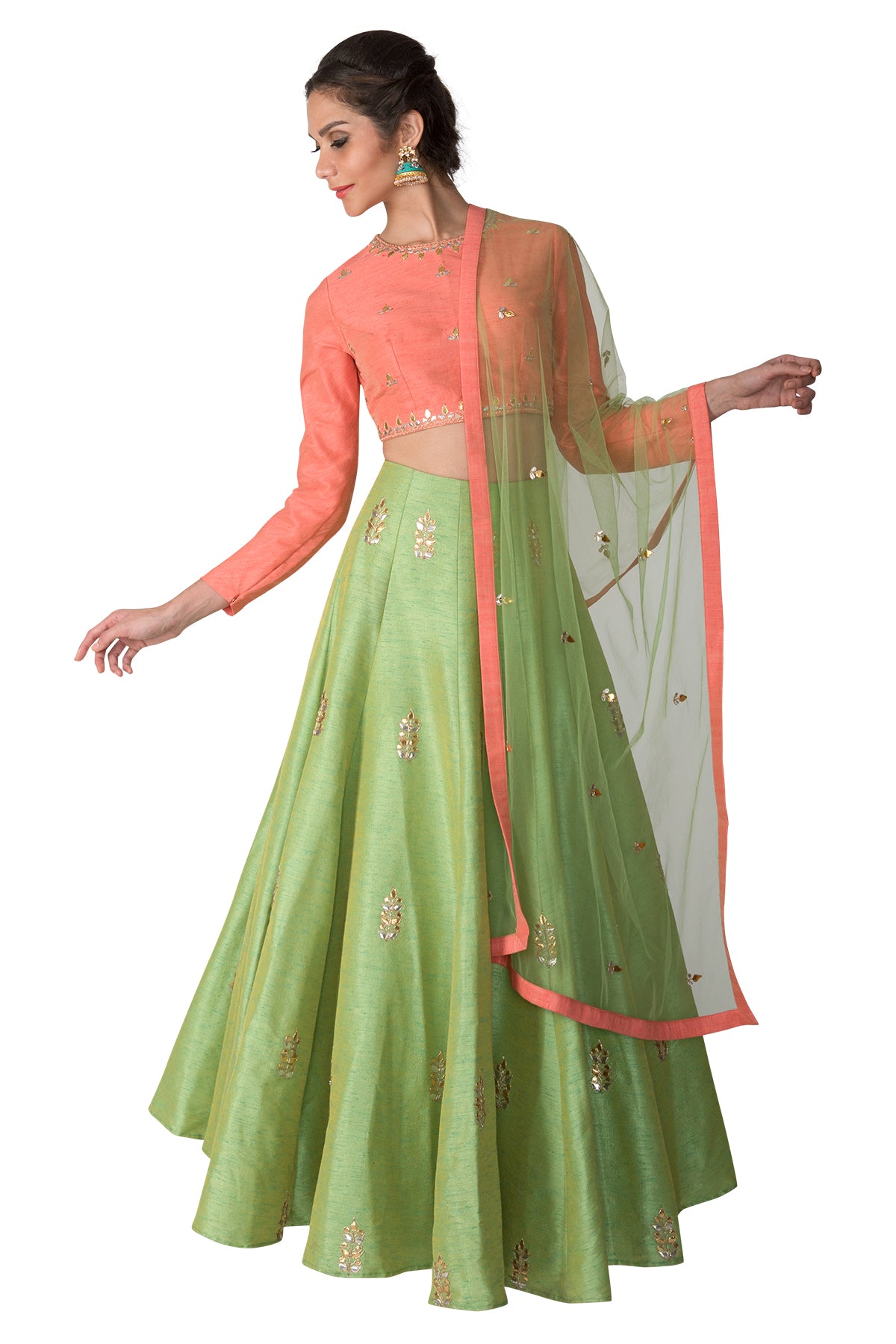Let this outfit bring a whiff of that perfect pastel palette to your wedding wardrobe with its peach embroidered full-sleeve blouse, green gota lehenga & green net dupatta.